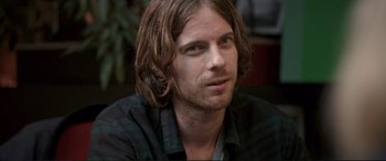 Movie still from “A Street Cat Named Bob” (2016), directed by Roger Spottiswoode – A person with long brown hair; Close Up shot, Over the shoulder angle