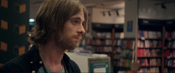 Movie still from “A Street Cat Named Bob” (2016), directed by Roger Spottiswoode – A person with long hair; Close Up shot, Over the shoulder angle