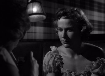 Movie still from “A Streetcar Named Desire” (1951), directed by Elia Kazan – A black - and - white photo of a woman looking at a man; Close Up shot, Over the shoulder angle