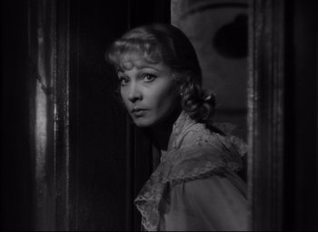 Movie still from “A Streetcar Named Desire” (1951), directed by Elia Kazan – A black - and - white photo of a woman looking out of a window; Close Up shot, Over the shoulder angle