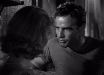 Movie still from “A Streetcar Named Desire” (1951), directed by Elia Kazan – A black and white photo of a man and a woman; Close Up shot, Over the shoulder angle