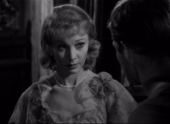 Movie still from “A Streetcar Named Desire” (1951), directed by Elia Kazan – A black - and - white photo of a woman looking at a mirror; Close Up shot, Over the shoulder angle