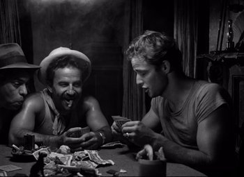 Movie still from “A Streetcar Named Desire” (1951), directed by Elia Kazan – Two men sitting at a dinner table playing cards; Medium shot, Over the shoulder angle