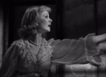 Movie still from “A Streetcar Named Desire” (1951), directed by Elia Kazan – An old photo of a woman wearing a dress; Close Up shot, Over the shoulder angle