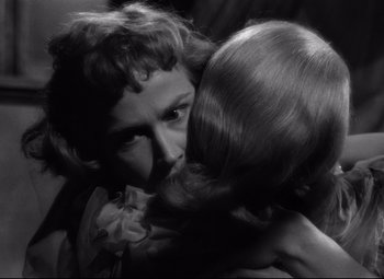 Movie still from “A Streetcar Named Desire” (1951), directed by Elia Kazan – Two women embracing each other in a black - and - white photo; Close Up shot, Over the shoulder angle