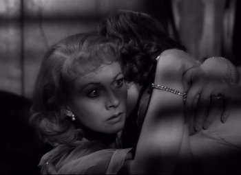 Movie still from “A Streetcar Named Desire” (1951), directed by Elia Kazan – A woman with her arm around another woman's shoulder; Close Up shot, Overhead angle