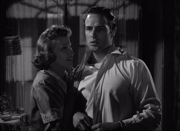 Movie still from “A Streetcar Named Desire” (1951), directed by Elia Kazan – A man and a woman standing next to each other; Medium shot, Low angle