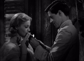 Movie still from “A Streetcar Named Desire” (1951), directed by Elia Kazan – A man and a woman are lighting a cigarette; Medium shot, Over the shoulder angle