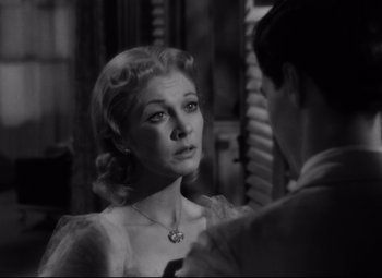Movie still from “A Streetcar Named Desire” (1951), directed by Elia Kazan – A black - and - white photo of a woman and a man; Close Up shot, Over the shoulder angle