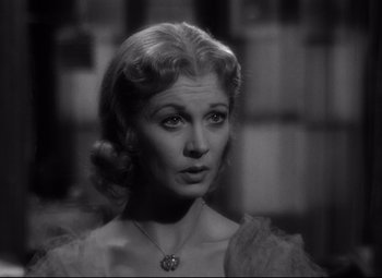 Movie still from “A Streetcar Named Desire” (1951), directed by Elia Kazan – A black - and - white photo of a woman in a dress; Close Up shot, Over the shoulder angle