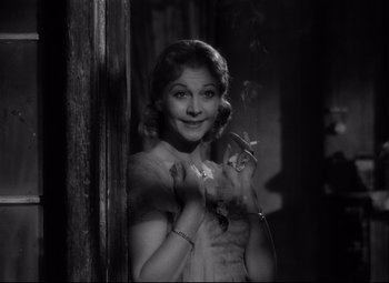 Movie still from “A Streetcar Named Desire” (1951), directed by Elia Kazan – A young woman standing next to a wooden pole; Close Up shot, Low angle