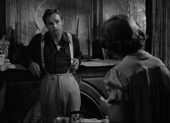 Movie still from “A Streetcar Named Desire” (1951), directed by Elia Kazan – A black and white photo of a man and a woman in front of a mirror; Medium shot, Over the shoulder angle