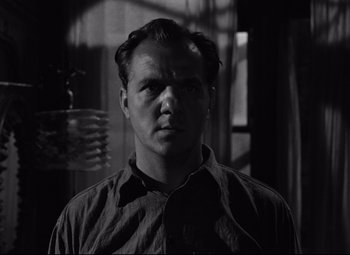 Movie still from “A Streetcar Named Desire” (1951), directed by Elia Kazan – A black and white photo of a man in a room; Close Up shot, Low angle