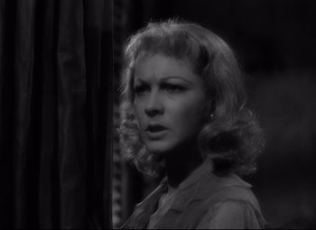 Movie still from “A Streetcar Named Desire” (1951), directed by Elia Kazan – A black - and - white photo of a woman in a dress; Close Up shot, Low angle