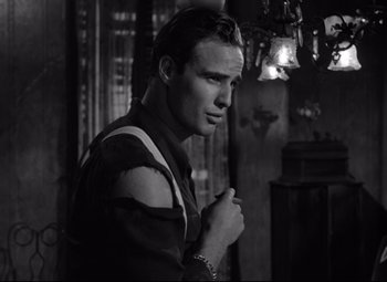Movie still from “A Streetcar Named Desire” (1951), directed by Elia Kazan – Black and white photograph of a young man in a room; Close Up shot, Low angle