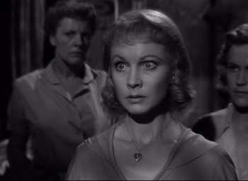 Movie still from “A Streetcar Named Desire” (1951), directed by Elia Kazan – A black - and - white photo of a woman and a man; Close Up shot, Over the shoulder angle