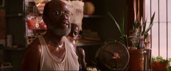 Movie still from “A Time to Kill” (1996), directed by Joel Schumacher – An older man with a beard and glasses; Close Up shot, Low angle
