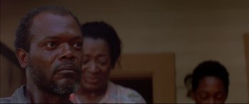 Movie still from “A Time to Kill” (1996), directed by Joel Schumacher – A man and a woman standing next to each other in a room; Close Up shot, Over the shoulder angle