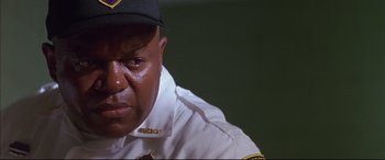 Movie still from “A Time to Kill” (1996), directed by Joel Schumacher – A person wearing a uniform; Close Up shot, Low angle