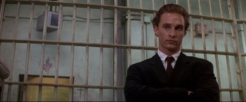 Movie still from “A Time to Kill” (1996), directed by Joel Schumacher – A man in a suit and tie standing in front of a jail cell; Close Up shot, Low angle
