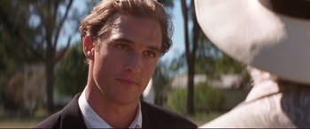 Movie still from “A Time to Kill” (1996), directed by Joel Schumacher – A person wearing a suit and tie; Close Up shot, Over the shoulder angle