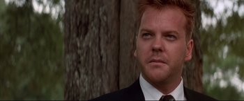 Movie still from “A Time to Kill” (1996), directed by Joel Schumacher – A person wearing a suit and tie; Close Up shot, Low angle