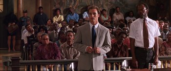 Movie still from “A Time to Kill” (1996), directed by Joel Schumacher – A man standing in front of a group of people; Medium shot, Low angle