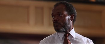 Movie still from “A Time to Kill” (1996), directed by Joel Schumacher – A man in a white shirt and a red neck tie; Close Up shot, Low angle