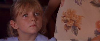 Movie still from “A Time to Kill” (1996), directed by Joel Schumacher – A little girl looking at a picture of a flower; Close Up shot, High angle