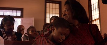 Movie still from “A Time to Kill” (1996), directed by Joel Schumacher – A group of people sitting in a room; Close Up shot, Over the shoulder angle