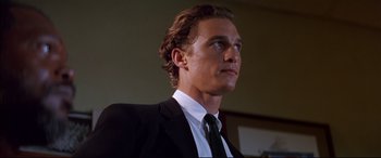 Movie still from “A Time to Kill” (1996), directed by Joel Schumacher – A person wearing a suit and tie; Close Up shot, Low angle
