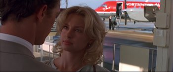 Movie still from “A Time to Kill” (1996), directed by Joel Schumacher – A woman standing in front of an airplane on a runway; Close Up shot, Over the shoulder angle
