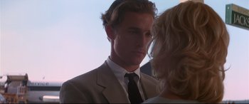Movie still from “A Time to Kill” (1996), directed by Joel Schumacher – A man in a white suit and a woman in a black tie; Close Up shot, Over the shoulder angle