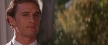 Movie still from “A Time to Kill” (1996), directed by Joel Schumacher – A man's face in front of a tree; Close Up shot, Low angle