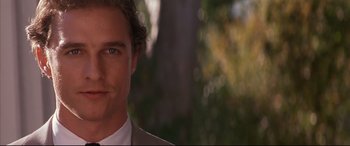 Movie still from “A Time to Kill” (1996), directed by Joel Schumacher – A person wearing a suit and tie; Close Up shot, Over the shoulder angle