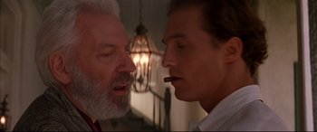 Movie still from “A Time to Kill” (1996), directed by Joel Schumacher – Two men one of whom is smoking a cigarette and one of whom has a beard; Close Up shot, Low angle