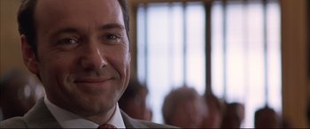 Movie still from “A Time to Kill” (1996), directed by Joel Schumacher – A person wearing a suit and tie; Close Up shot, Over the shoulder angle