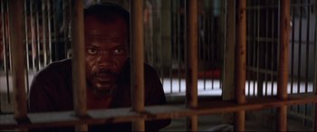Movie still from “A Time to Kill” (1996), directed by Joel Schumacher – A man in a jail cell looking through the bars; Close Up shot, High angle