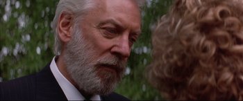 Movie still from “A Time to Kill” (1996), directed by Joel Schumacher – An older man in a suit and a white beard; Close Up shot, Over the shoulder angle