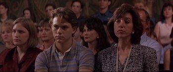 Movie still from “A Time to Kill” (1996), directed by Joel Schumacher – A group of people sitting next to each other in a room; Close Up shot, Over the shoulder angle