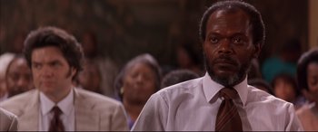 Movie still from “A Time to Kill” (1996), directed by Joel Schumacher – A person wearing a suit and a tie; Close Up shot, Low angle