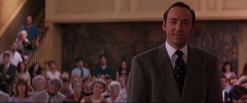 Movie still from “A Time to Kill” (1996), directed by Joel Schumacher – A man in a suit and tie standing in front of a crowd; Close Up shot, Low angle