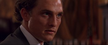 Movie still from “A Time to Kill” (1996), directed by Joel Schumacher – A person wearing a suit and tie; Close Up shot, Over the shoulder angle
