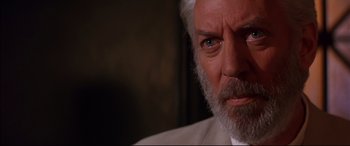 Movie still from “A Time to Kill” (1996), directed by Joel Schumacher – An old man with a beard and a white beard; Close Up shot, Over the shoulder angle