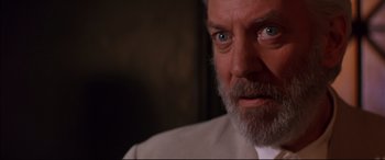 Movie still from “A Time to Kill” (1996), directed by Joel Schumacher – A man with a beard and a white shirt is looking at the camera; Close Up shot, Low angle