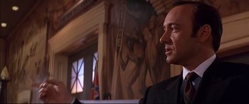 Movie still from “A Time to Kill” (1996), directed by Joel Schumacher – A person in a suit near a wall; Close Up shot, Low angle