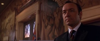 Movie still from “A Time to Kill” (1996), directed by Joel Schumacher – A person wearing a suit and tie; Close Up shot, Low angle
