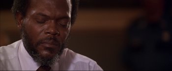 Movie still from “A Time to Kill” (1996), directed by Joel Schumacher – A person with his eyes closed; Close Up shot, Low angle