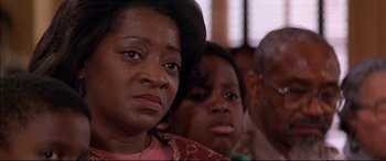 Movie still from “A Time to Kill” (1996), directed by Joel Schumacher – A woman and two boys sitting in front of each other; Close Up shot, Over the shoulder angle