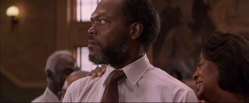 Movie still from “A Time to Kill” (1996), directed by Joel Schumacher – A man in a white dress shirt and a brown neck tie; Close Up shot, Low angle